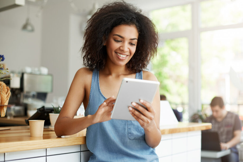 African female looking at results on her tablet