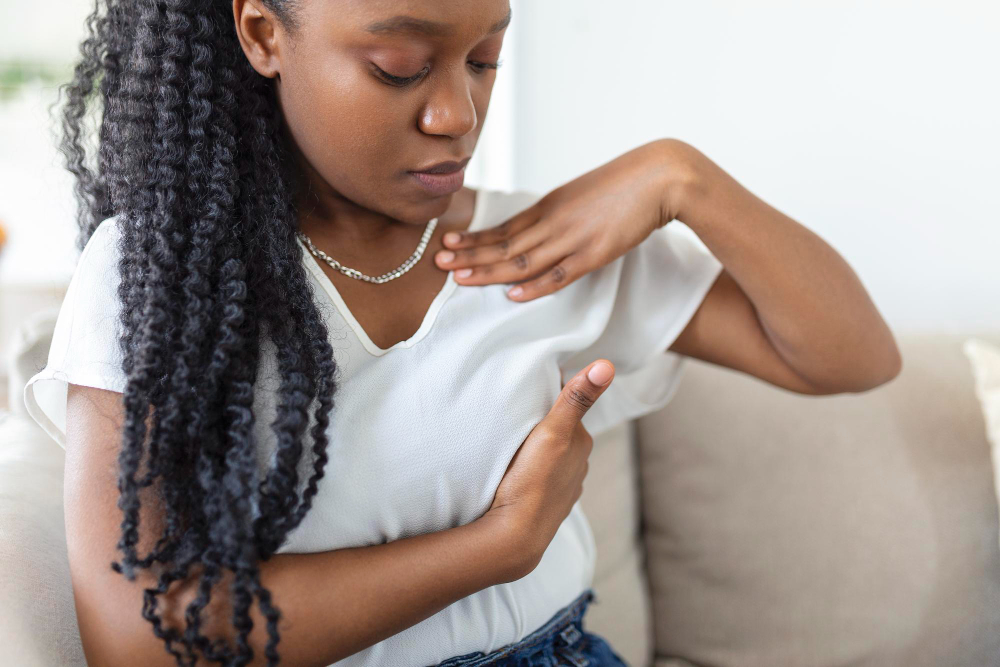 woman performing self breast exam