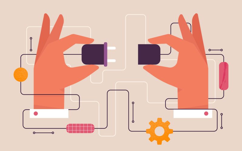 Two hands connecting an electric plug and a power socket together.